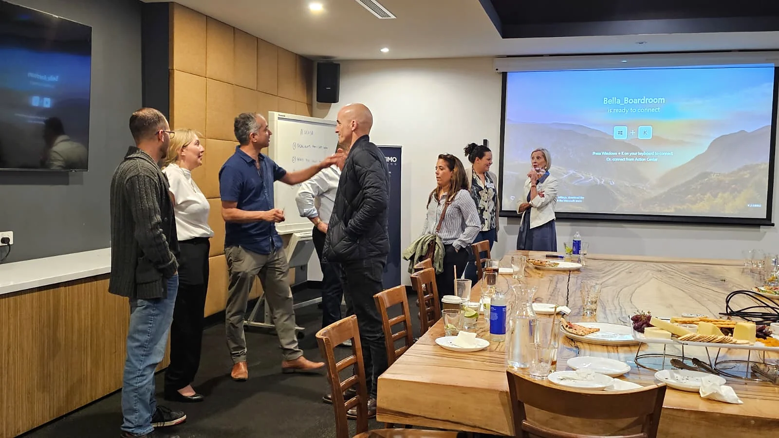Toolbox attendees meeting beside an event presentation